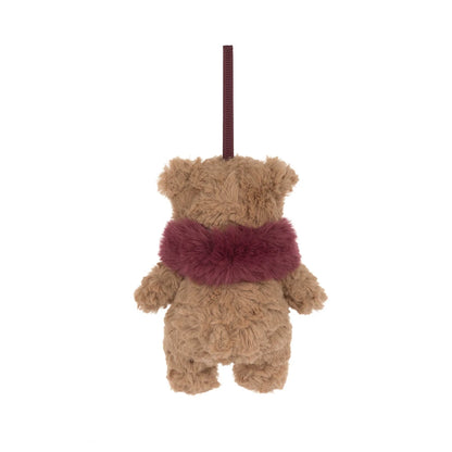 A small plush teddy bear ornament or hanging decoration in tan brown fur with a fuzzy burgundy scarf and a matching hanging loop, shown on a plain white background.