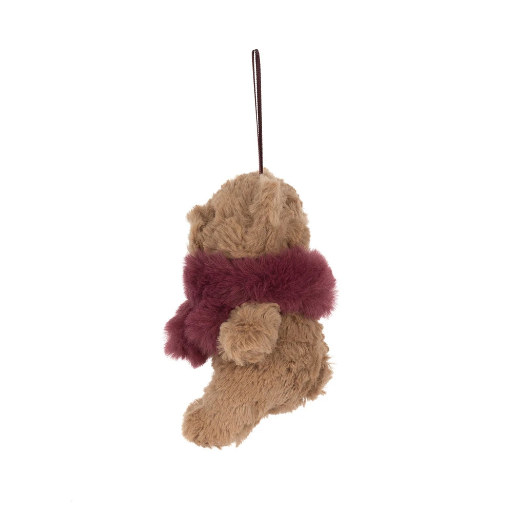 A plush teddy bear Christmas  ornament in tan with a burgundy faux-fur scarf and a dark hanging loop, shown against a plain white background.