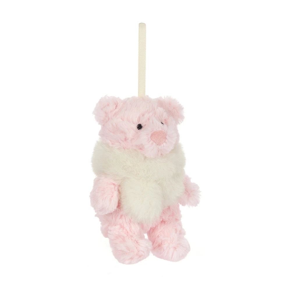 A small plush teddy bear hanging ornament in soft pink and cream white, with a cream ribbon loop at the top, shown on a plain white background.