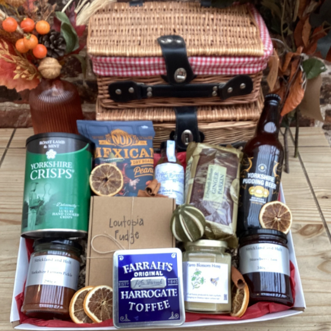 Hamper with crisps, toffee, fudge, ginger cake, honey jam and pickle